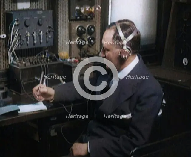 Italian Senator Guglielmo Marconi Using Radio Apparatus While Taking Notes, 1920. Creator: British Pathe Ltd.
