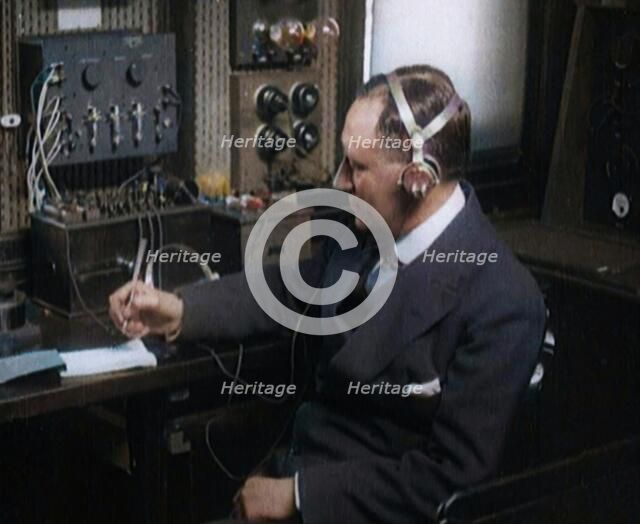 Italian Senator Guglielmo Marconi Using Radio Apparatus While Taking Notes, 1920. Creator: British Pathe Ltd.