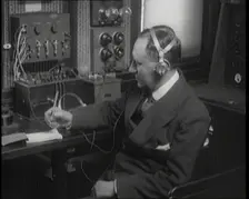 Italian Senator Guglielmo Marconi Using Radio Apparatus While Taking Notes, 1920. Creator: British Pathe Ltd