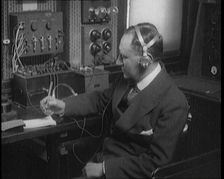 Italian Senator Guglielmo Marconi Using Radio Apparatus While Taking Notes, 1920. Creator: British Pathe Ltd
