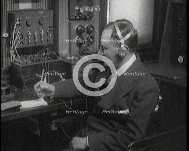 Italian Senator Guglielmo Marconi Using Radio Apparatus While Taking Notes, 1920. Creator: British Pathe Ltd.