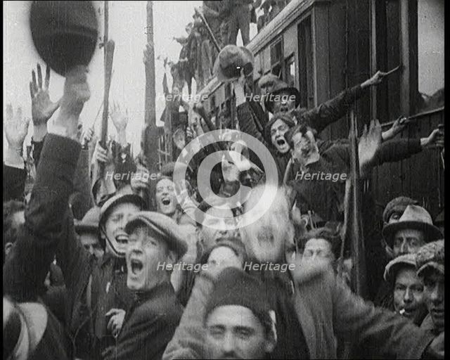 Italian Soldiers Standing on or Near a Train, Waving and Cheering, 1922. Creator: British Pathe Ltd.