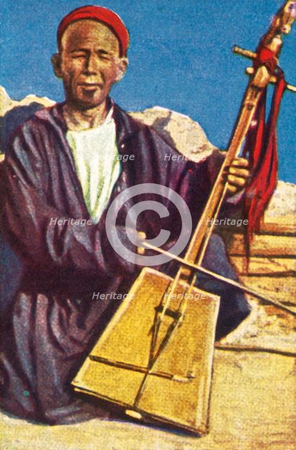 Itinerant musician, Mongolia, c1928. Creator: Unknown.