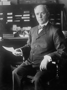 J.D. Archbold, seated holding paper, 1911. Creator: Bain News Service