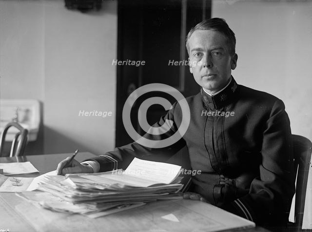 J.P. Auld, U.S.N. at Desk, 1917. Creator: Harris & Ewing.