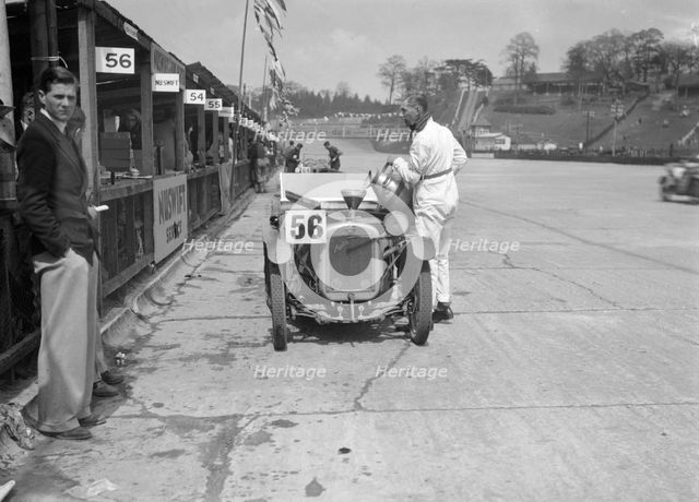 J Reeves and HHB Beacon's Austin Ulster in the pits, JCC Double Twelve race, Brooklands, 1931. Artist: Bill Brunell.