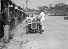 J Reeves and HHB Beacon's Austin Ulster in the pits, JCC Double Twelve race, Brooklands, 1931. Artist: Bill Brunell