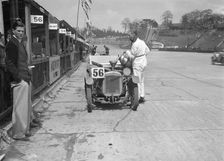 J Reeves and HHB Beacon's Austin Ulster in the pits, JCC Double Twelve race, Brooklands, 1931. Artist: Bill Brunell