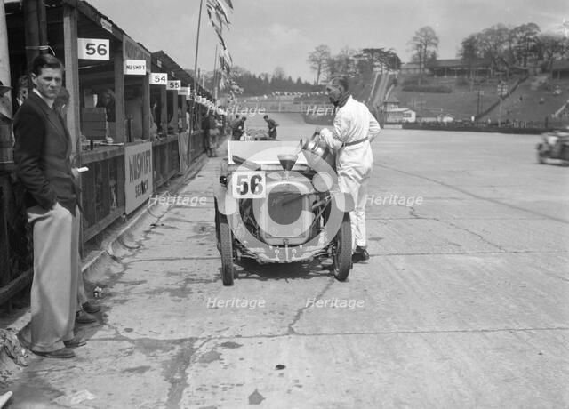 J Reeves and HHB Beacon's Austin Ulster in the pits, JCC Double Twelve race, Brooklands, 1931. Artist: Bill Brunell.