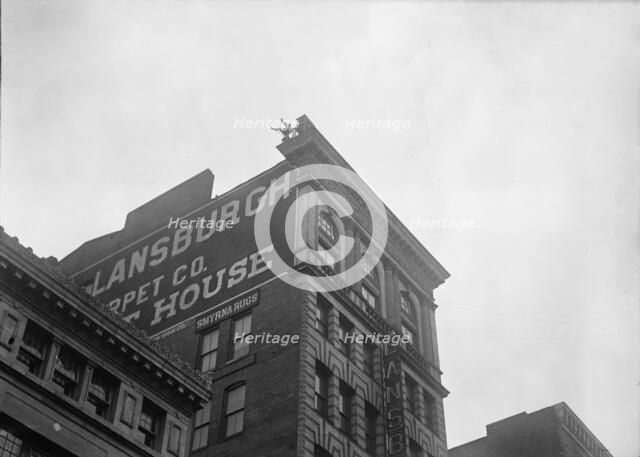 J. Reynolds, Performing Acrobatic And Balancing Acts On High Cornice Above 9th Street, N.W., 1917. Creator: Harris & Ewing.