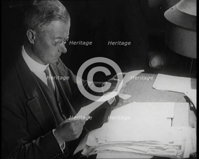 Journalist at Work Reading Notes, 1921. Creator: British Pathe Ltd.