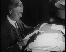 Journalist at Work Reading Notes, 1921. Creator: British Pathe Ltd