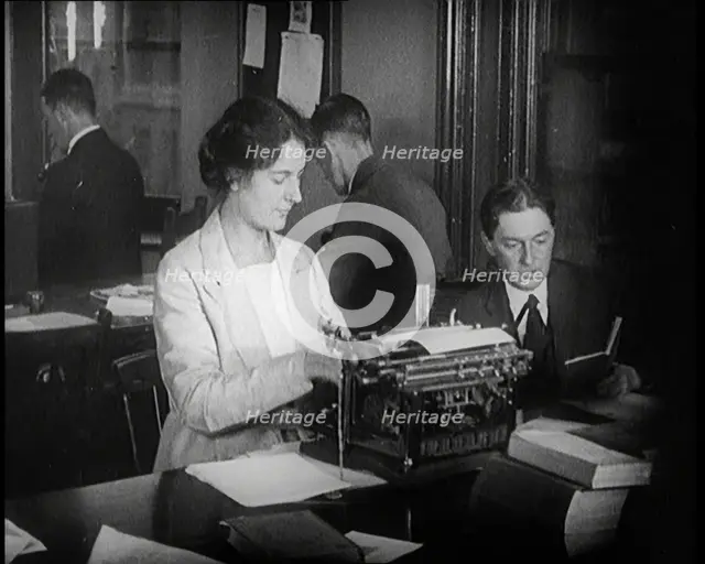 Journalists at Work Typing, Reading, and Making Notes. a Woman Is Typing What Is Being..., 1921. Creator: British Pathe Ltd.