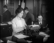 Journalists at Work Typing, Reading, and Making Notes. a Woman Is Typing What Is Being..., 1921. Creator: British Pathe Ltd