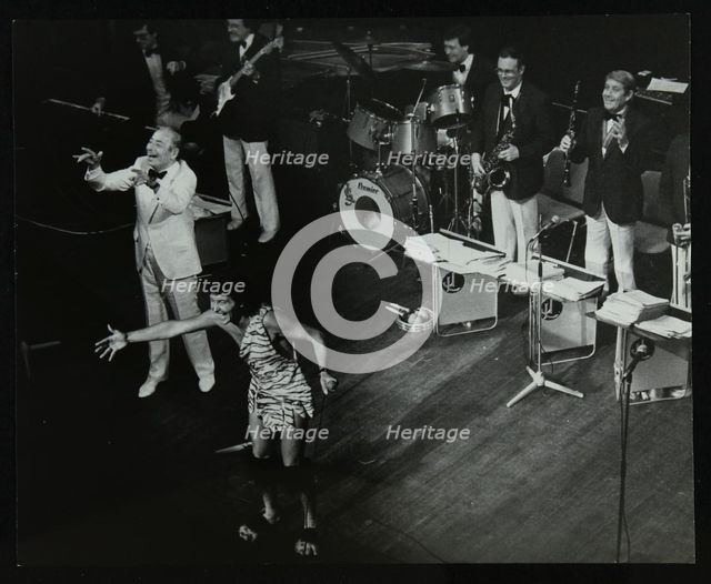 Joe Loss (left) on stage with his orchestra at the Forum Theatre, Hatfield, Hertfordshire, 1986. Artist: Denis Williams