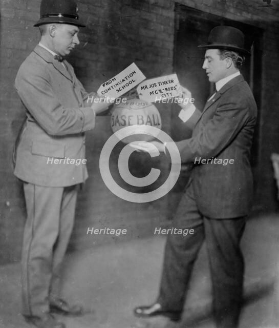 Joe Tinker receiving medicine ball sent by Continuation School 1913, 1913. Creator: Bain News Service.