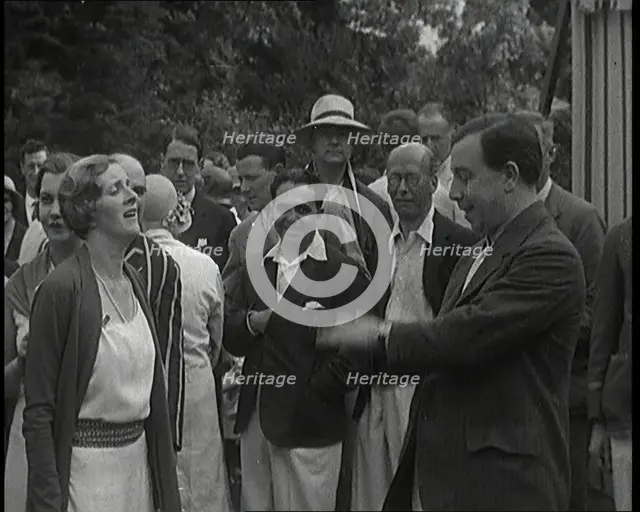 John Bonyton Priestley Tosses a Coin With Gladys Cooper, 1920s. Creator: British Pathe Ltd.
