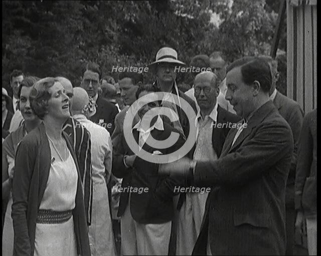 John Bonyton Priestley Tosses a Coin With Gladys Cooper, 1920s. Creator: British Pathe Ltd.