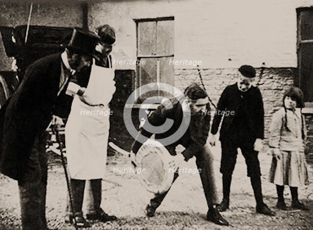 John Boyd Dunlop experiments with his pneumatic tire wheel, End of 1880s. Creator: Anonymous.
