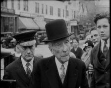 John D Rockefeller in a Suit and Hat Getting Out of a Car, 1932. Creator: British Pathe Ltd