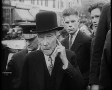John D. Rockefeller Standing with Other People Next to a Car, 1933. Creator: British Pathe Ltd