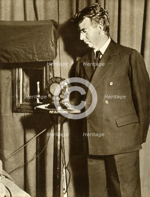 John Logie Baird watching the first play to be televised, 14 July 1930, (1935). Creator: Unknown.