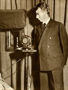 John Logie Baird watching the first play to be televised, 14 July 1930, (1935). Creator: Unknown