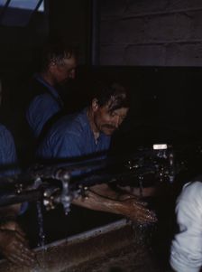 John Sabados washing up after a day's work..., Proviso yard of C & NW RR, Chicago, Ill., 1943. Creator: Jack Delano