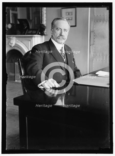 John Skelton Williams at desk, between 1913 and 1918. Creator: Harris & Ewing.
