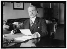 John Skelton Williams at Desk, between 1913 and 1918. Creator: Harris & Ewing