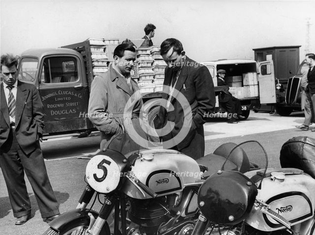 John Surtees with Nortons in paddock at 1954 Isle of Man T.T.. Creator: Unknown.