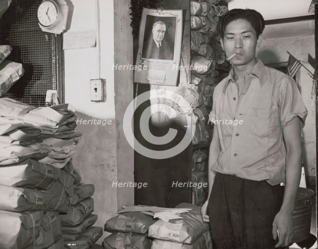 Johnnie Lew, owner of the laundry under the apartment of Mrs. Ella..., Washington, D.C., 1942. Creator: Gordon Parks.