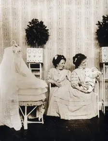 Josefa Blazek and Rosalia Blazek (Rosa Blazek), female conjoined twins, seated, holding...c1910. Creator: Unknown