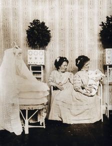 Josefa Blazek and Rosalia Blazek (Rosa Blazek), female conjoined twins, seated, holding...c1910. Creator: Unknown