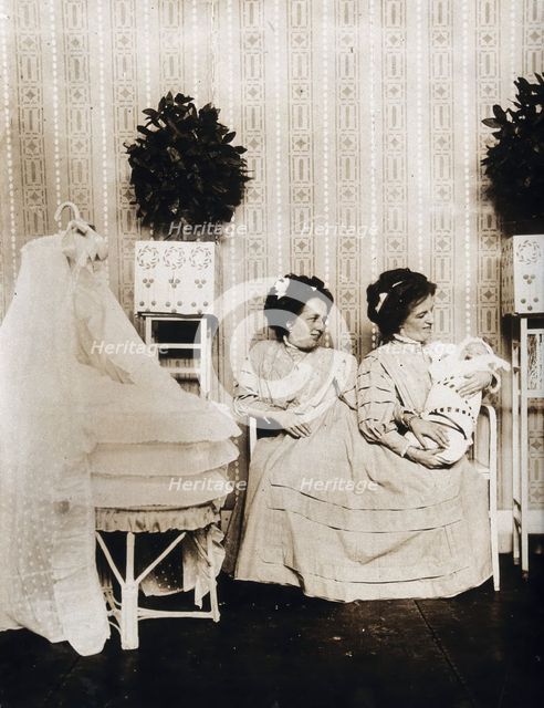 Josefa Blazek and Rosalia Blazek (Rosa Blazek), female conjoined twins, seated, holding...c1910. Creator: Unknown.
