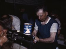 Joseph Klesken washing up after a day's work...Proviso yards of the C & NW RR, Chicago, Ill., 1943. Creator: Jack Delano
