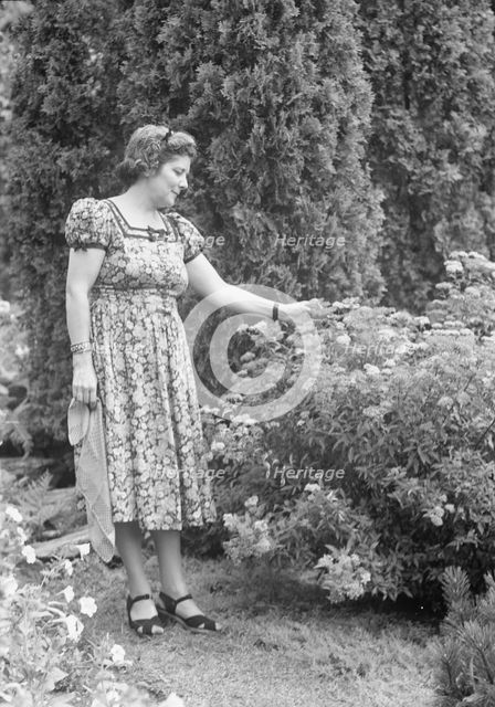 Javits, Benjamin, Mrs., standing outdoors, ca. 1925. Creator: Arnold Genthe.