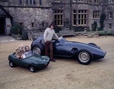 Jackie Stewart posing with a 1957 BRM