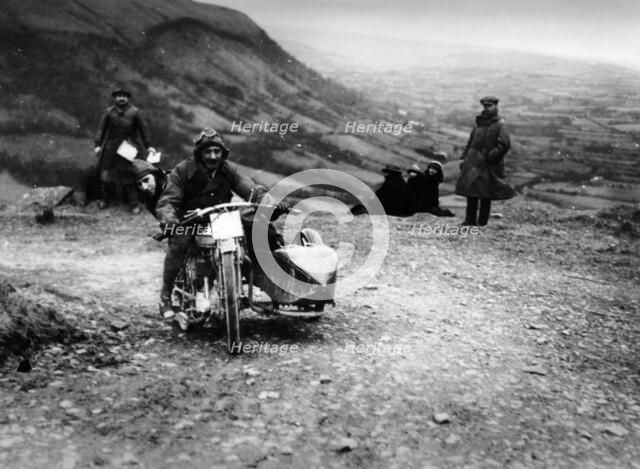 Jack Thomas riding a Norton, competing in the South Wales Trial, 1921. Artist: Unknown