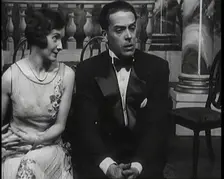 Jack Buchanan and June Knight Sitting on a Bench Together. Buchanan Looking Uncomfortable...,1920s Creator: British Pathe Ltd