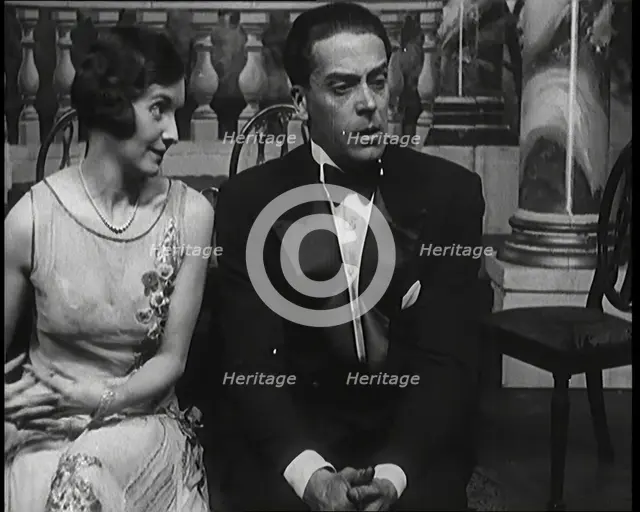 Jack Buchanan and June Knight Sitting on a Bench Together. Buchanan Looking Uncomfortable...,1920s Creator: British Pathe Ltd.