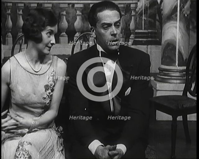 Jack Buchanan and June Knight Sitting on a Bench Together. Buchanan Looking Uncomfortable...,1920s Creator: British Pathe Ltd.