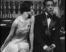 Jack Buchanan and June Knight Sitting on a Bench Together. Buchanan Looking Uncomfortable...,1920s Creator: British Pathe Ltd