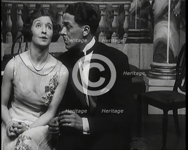 Jack Buchanan and June Knight Sitting on a Bench Together. Buchanan Looking Uncomfortable...,1920s Creator: British Pathe Ltd.