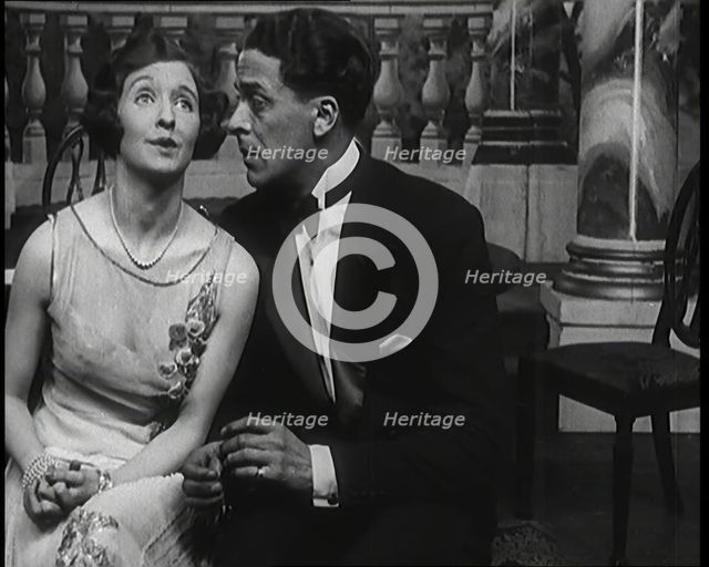 Jack Buchanan and June Knight Sitting on a Bench Together. Buchanan Looking Uncomfortable...,1920s Creator: British Pathe Ltd.