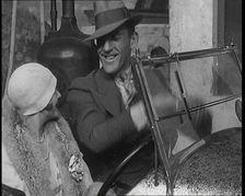 Jack Hulbert Climbing Into a Car And Getting His Fingers Stuck in Windscreen, 1920s. Creator: British Pathe Ltd
