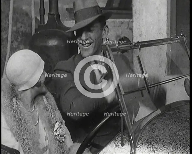 Jack Hulbert Climbing Into a Car And Getting His Fingers Stuck in Windscreen, 1920s. Creator: British Pathe Ltd.