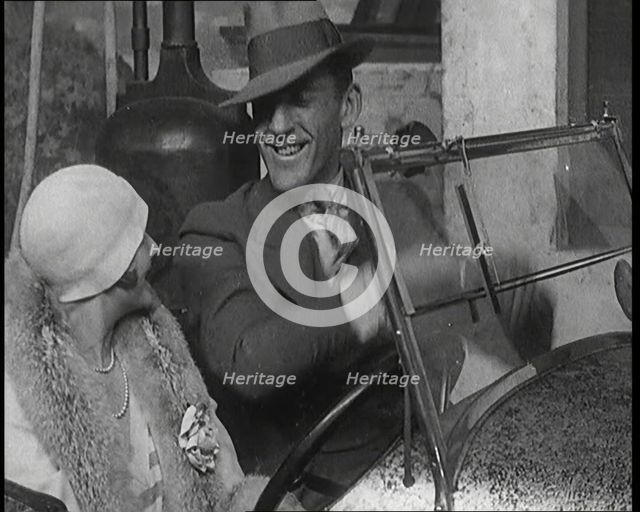 Jack Hulbert Climbing Into a Car And Getting His Fingers Stuck in Windscreen, 1920s. Creator: British Pathe Ltd.