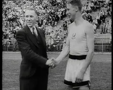 Jack Lovelock Shaking Hands With Someone as Crowds Watch, 1930s. Creator: British Pathe Ltd