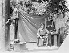 Jack Neill, "migratory fruit tramp," on banks of Pulah Creek near Winters, California, 1935. Creator: Dorothea Lange